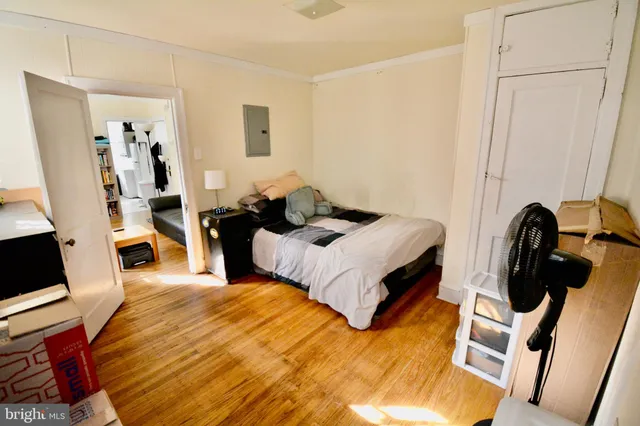 a bed room with a bed and a chair