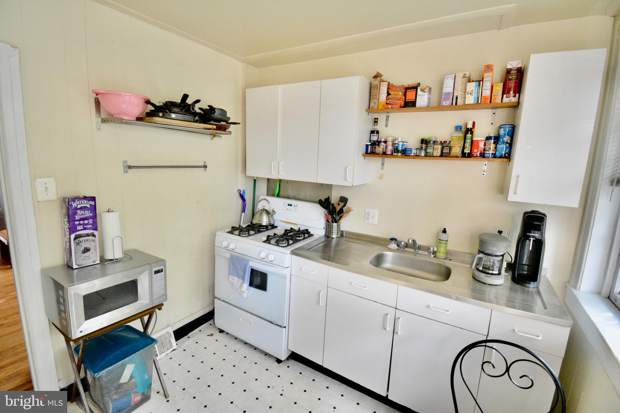 506 West Coulter Street, Unit 1 Philadelphia, PA 19144 - Photo 8 of 11 a kitchen with a refrigerator and white cabinets