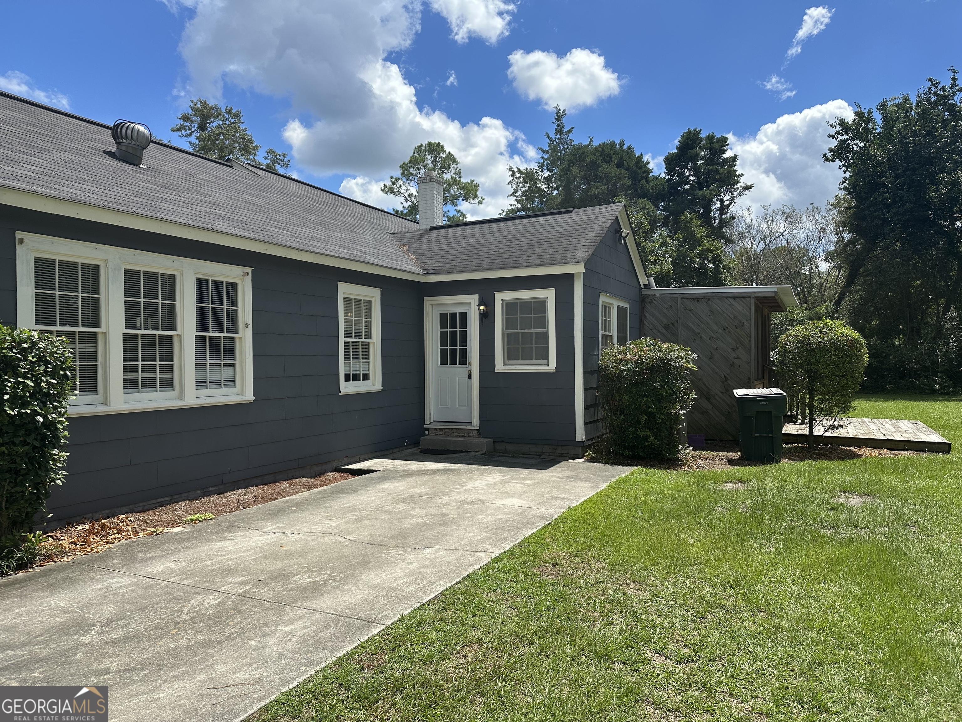 202 Geneva Street Dublin, GA 31021 - Photo 3 of 14 a backyard of a house with table and chairs