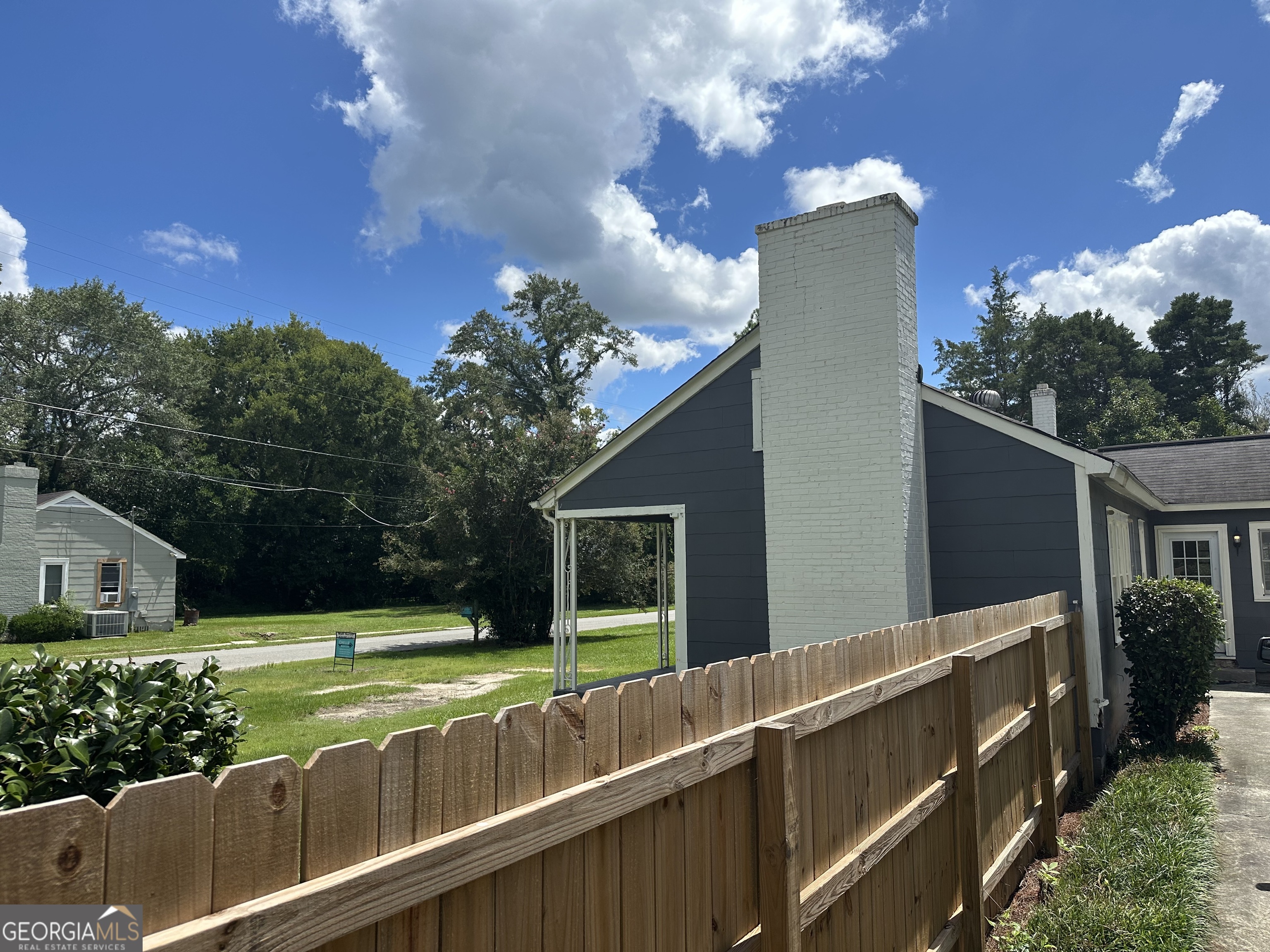 202 Geneva Street Dublin, GA 31021 - Photo 4 of 14 a view of a house with a backyard