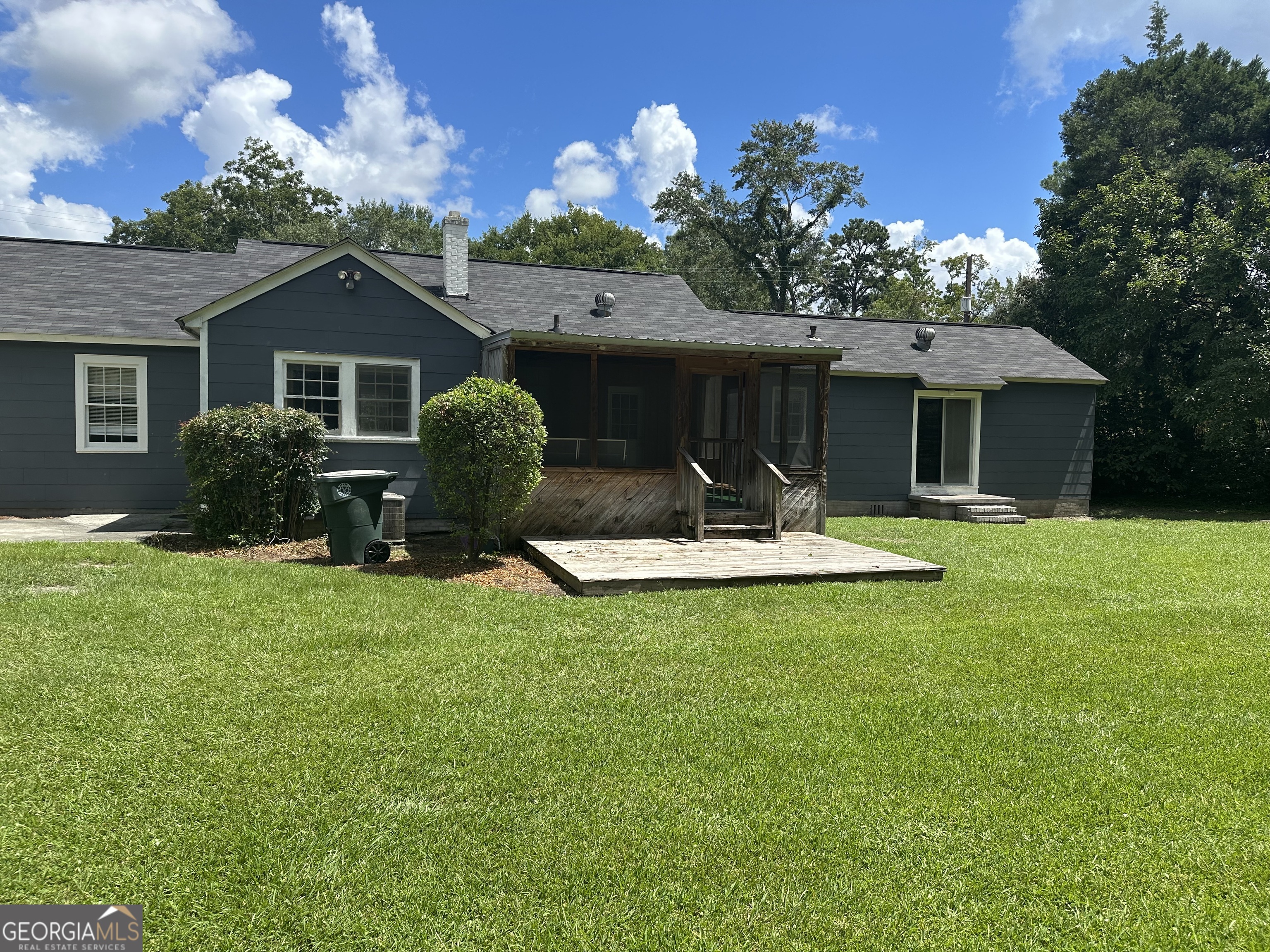 202 Geneva Street Dublin, GA 31021 - Photo 5 of 14 a front view of a house with patio yard and outdoor seating