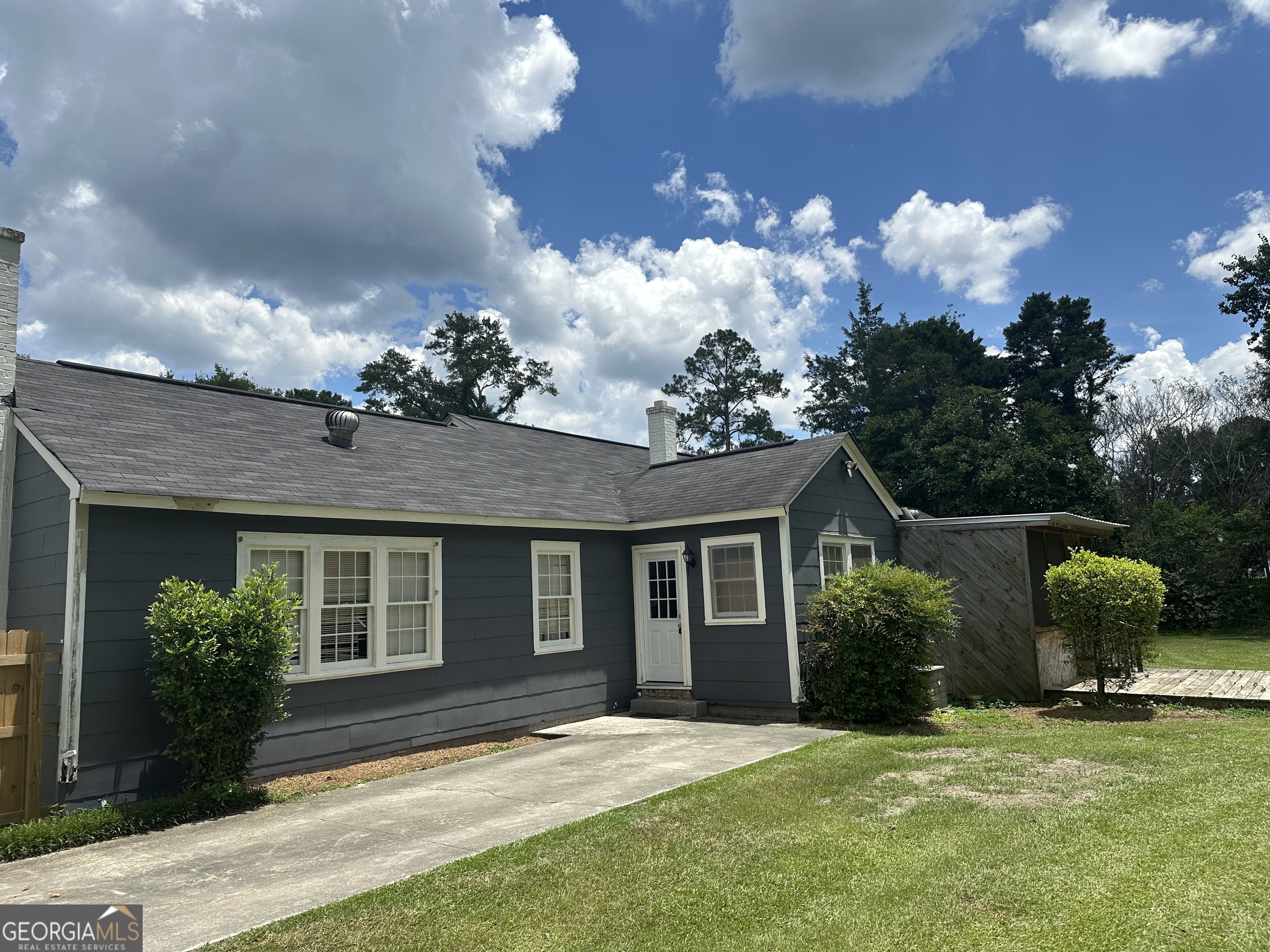 202 Geneva Street Dublin, GA 31021 - Photo 6 of 14 a front view of a house with garden