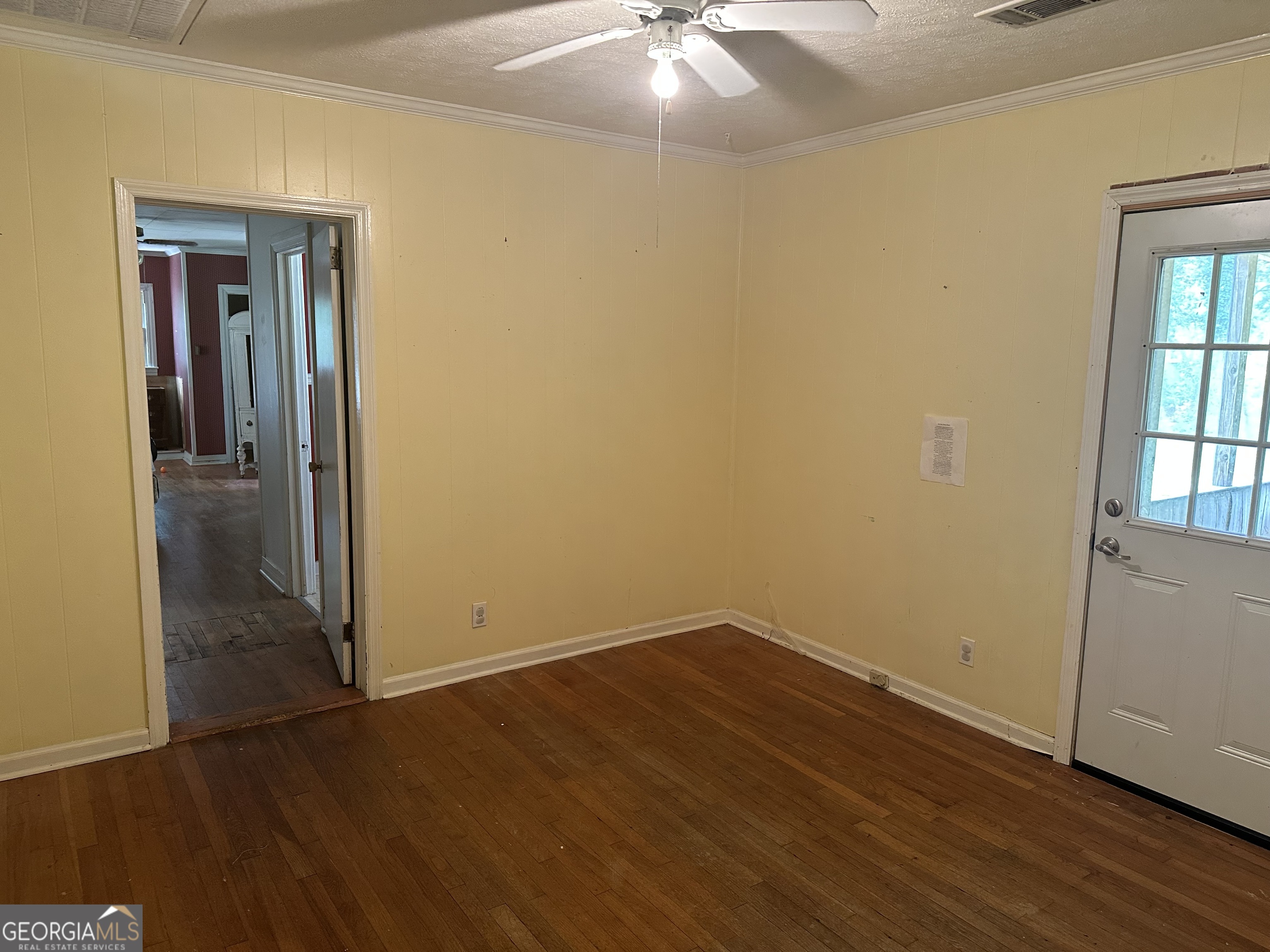 202 Geneva Street Dublin, GA 31021 - Photo 8 of 14 an empty room with wooden floor and windows