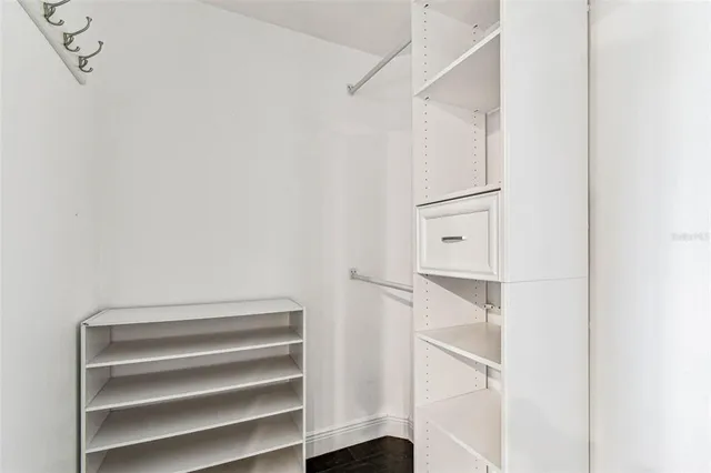 a kitchen with stainless steel appliances kitchen island granite countertop a refrigerator and a sink