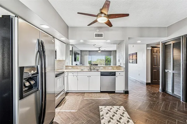 a swimming pool with outdoor seating and plants