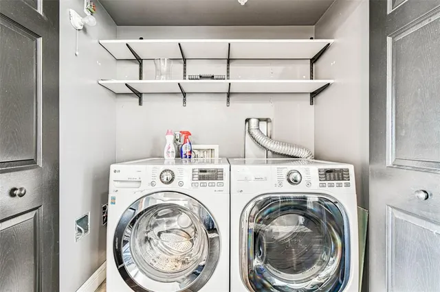 an aerial view of a city with lots of residential buildings ocean and mountain view in back