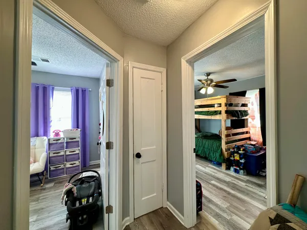 a view of a hallway with livingroom and furniture