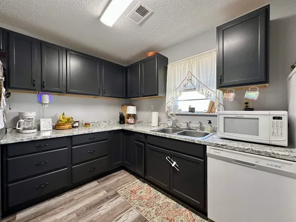a kitchen with a sink and cabinets