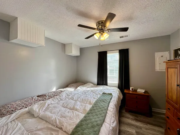 a bedroom with a bed and a chandelier