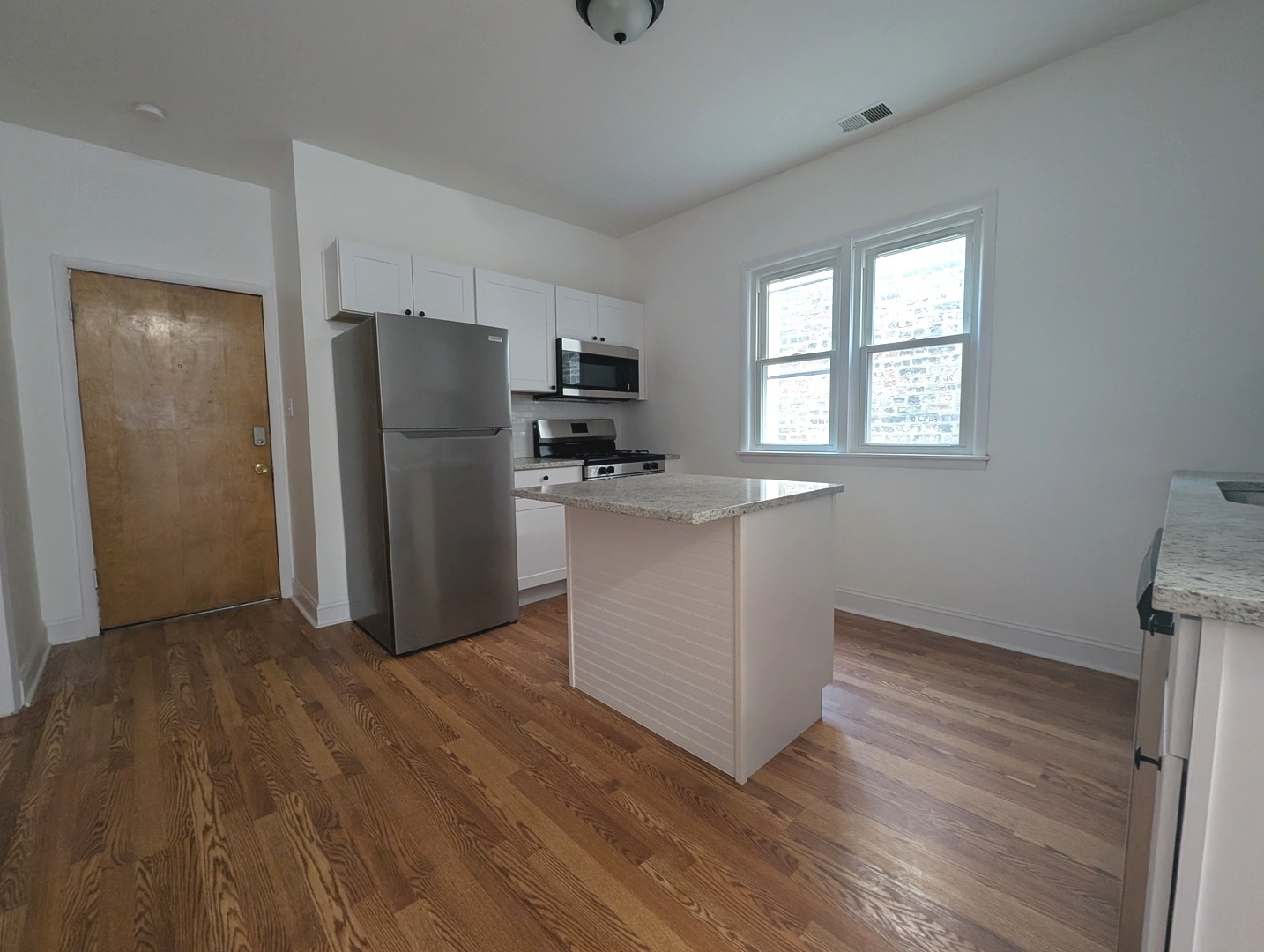 1520 West Melrose Street, Unit 2F Chicago, IL 60657 - Photo 5 of 16 a kitchen with a refrigerator sink and cabinets