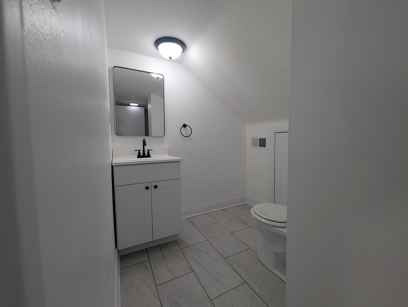 1520 West Melrose Street, Unit 2F Chicago, IL 60657 - Photo 9 of 16 a bathroom with a sink toilet and mirror
