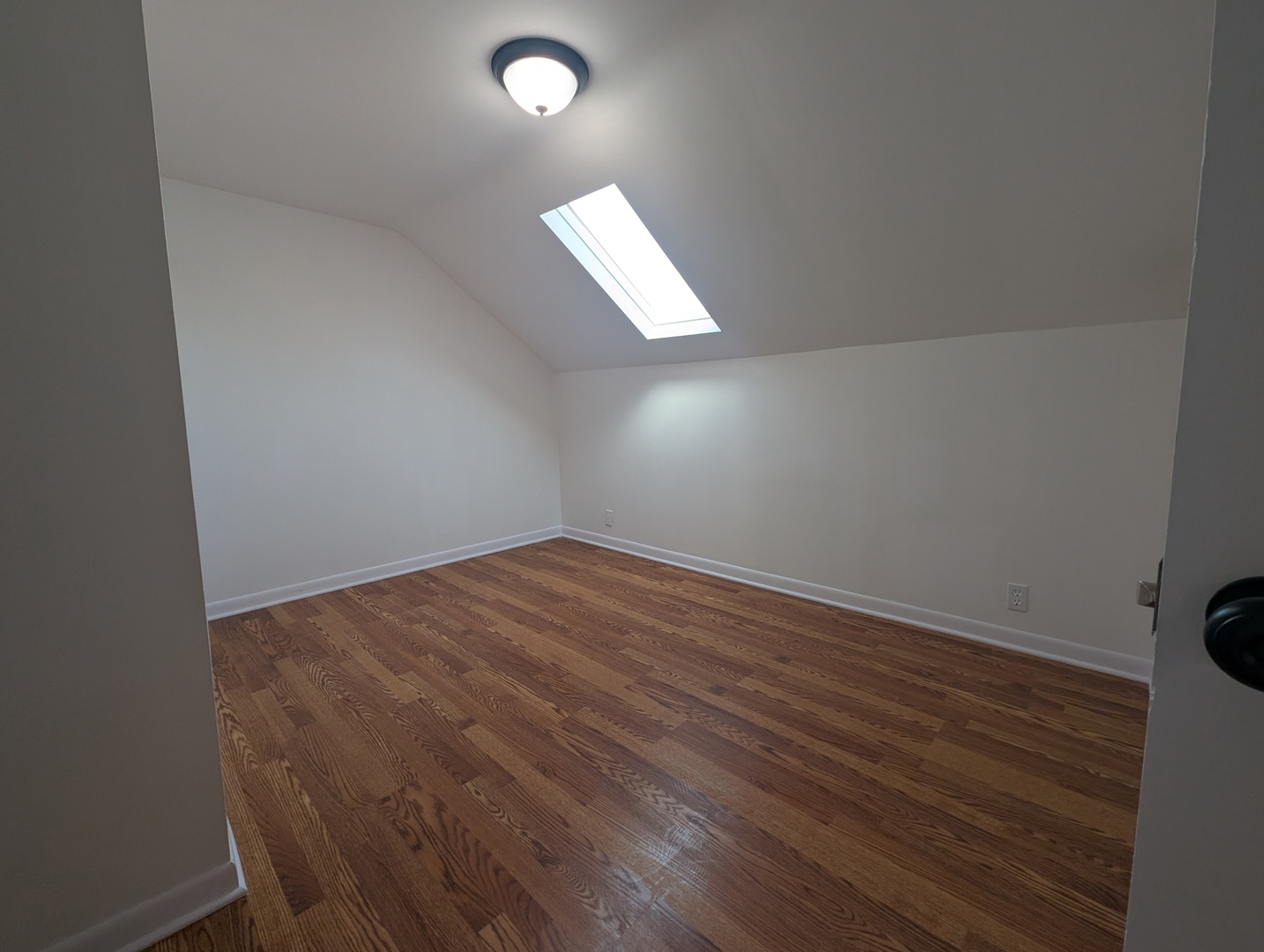 1520 West Melrose Street, Unit 2F Chicago, IL 60657 - Photo 10 of 16 an empty room with wooden floor and windows
