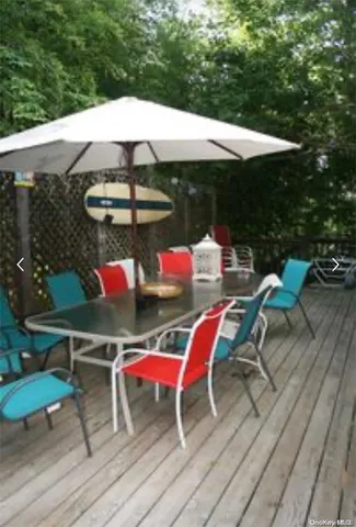 an outdoor sitting area with furniture and umbrella