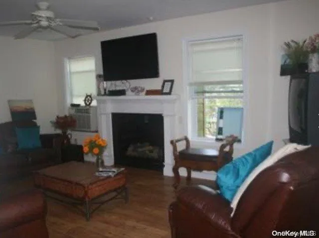 a living room with furniture a flat screen tv and a fireplace