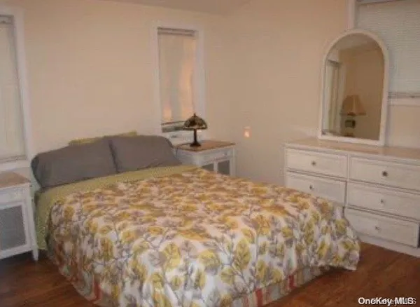 a bedroom with a bed and mirror
