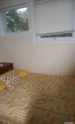 a view of a room with an empty space and a window