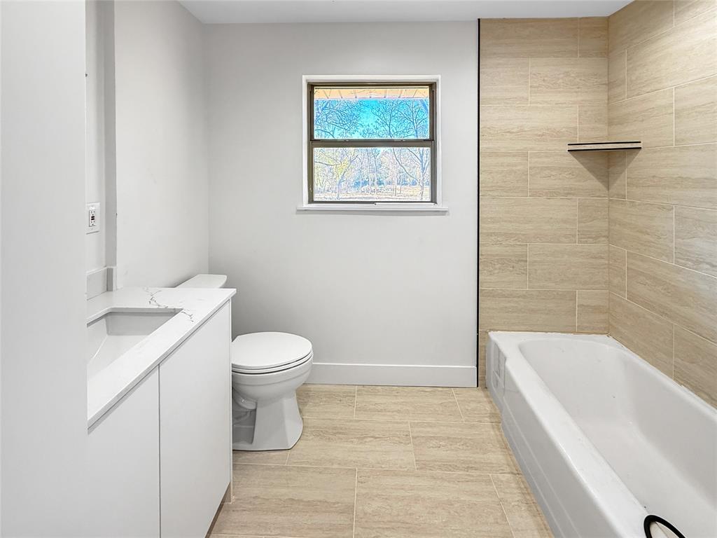 425 Chesier Road Lancaster, TX 75146 - Photo 11 of 15 a bathroom with a sink a toilet and shower