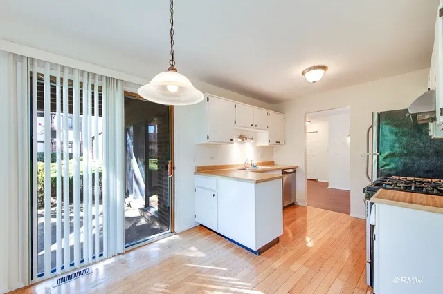 a kitchen with stainless steel appliances a stove a sink a stove and a refrigerator