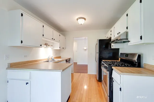 a view of a hallway with wooden floor