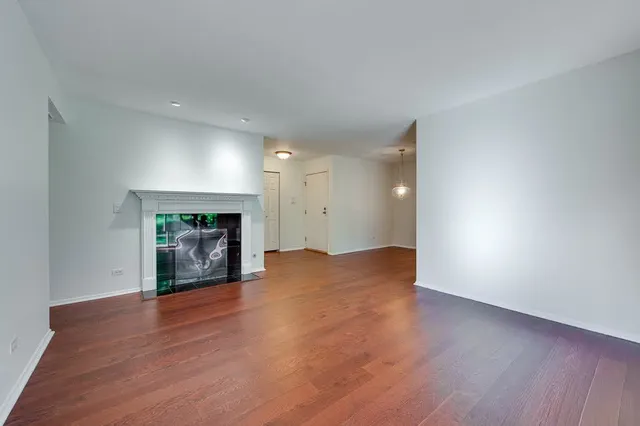 a view of a room with wooden floor and windows