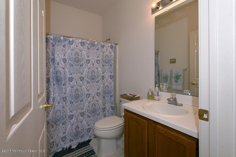 48 Quail Road Barnegat, NJ 08005 - Photo 11 of 19 a bathroom with a sink a toilet and shower