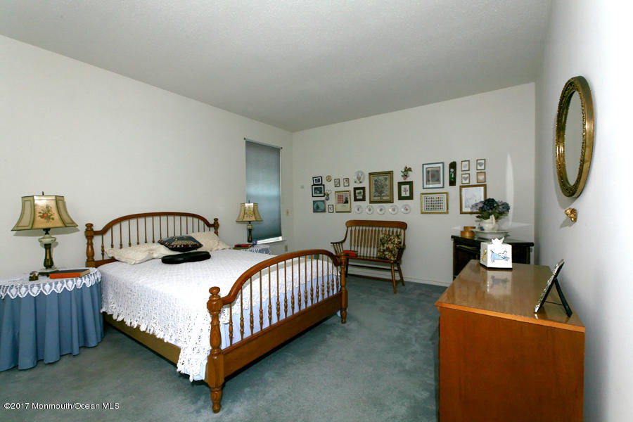 48 Quail Road Barnegat, NJ 08005 - Photo 15 of 19 a bedroom with a bed a mirror and dresser