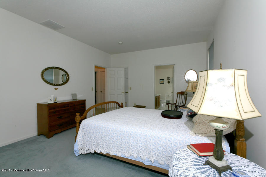48 Quail Road Barnegat, NJ 08005 - Photo 16 of 19 a bedroom with a bed and a lamp