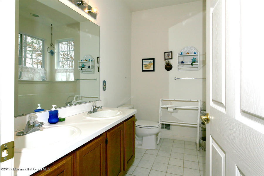 48 Quail Road Barnegat, NJ 08005 - Photo 17 of 19 a bathroom with a sink and a mirror