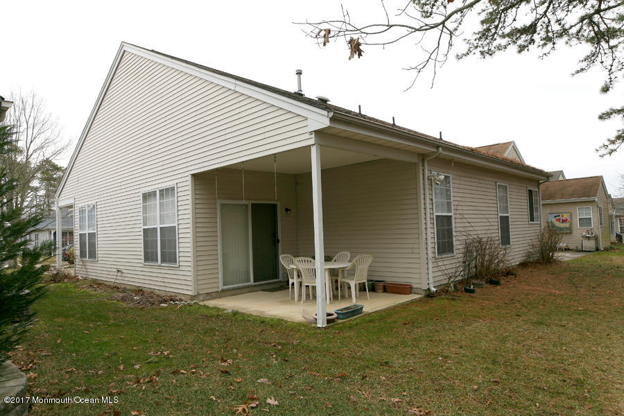 48 Quail Road Barnegat, NJ 08005 - Photo 3 of 19 a backyard of a house with table and chairs