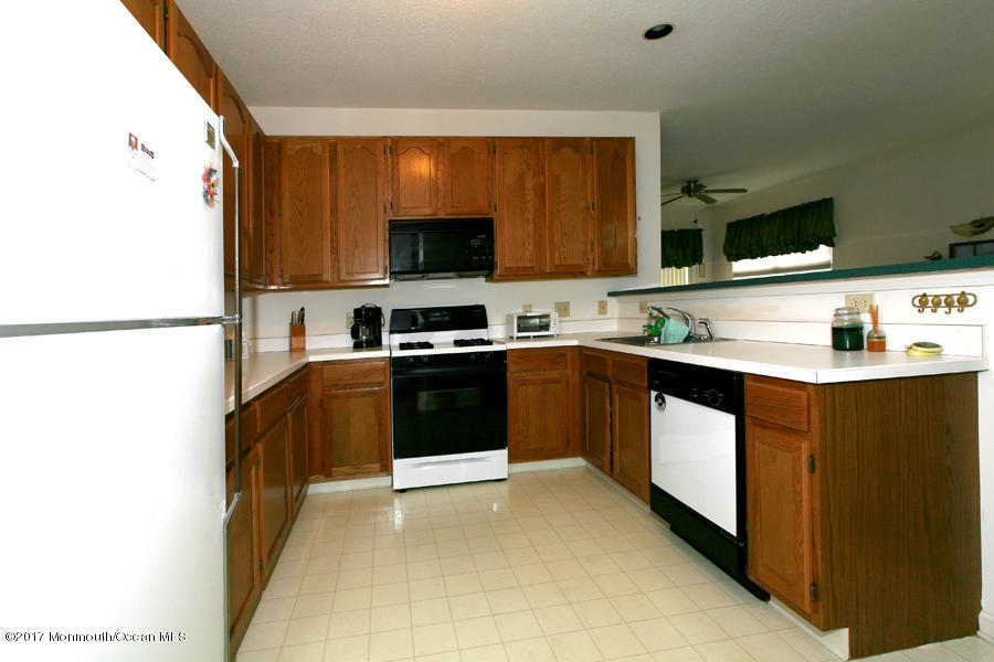 48 Quail Road Barnegat, NJ 08005 - Photo 6 of 19 a kitchen with stainless steel appliances granite countertop a sink stove and refrigerator