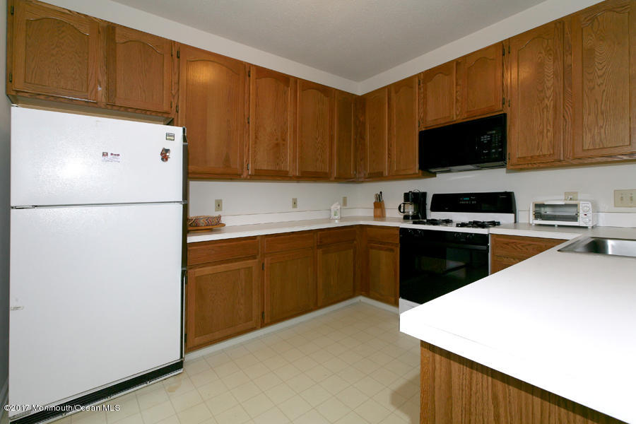 48 Quail Road Barnegat, NJ 08005 - Photo 7 of 19 a kitchen with a sink a stove and refrigerator