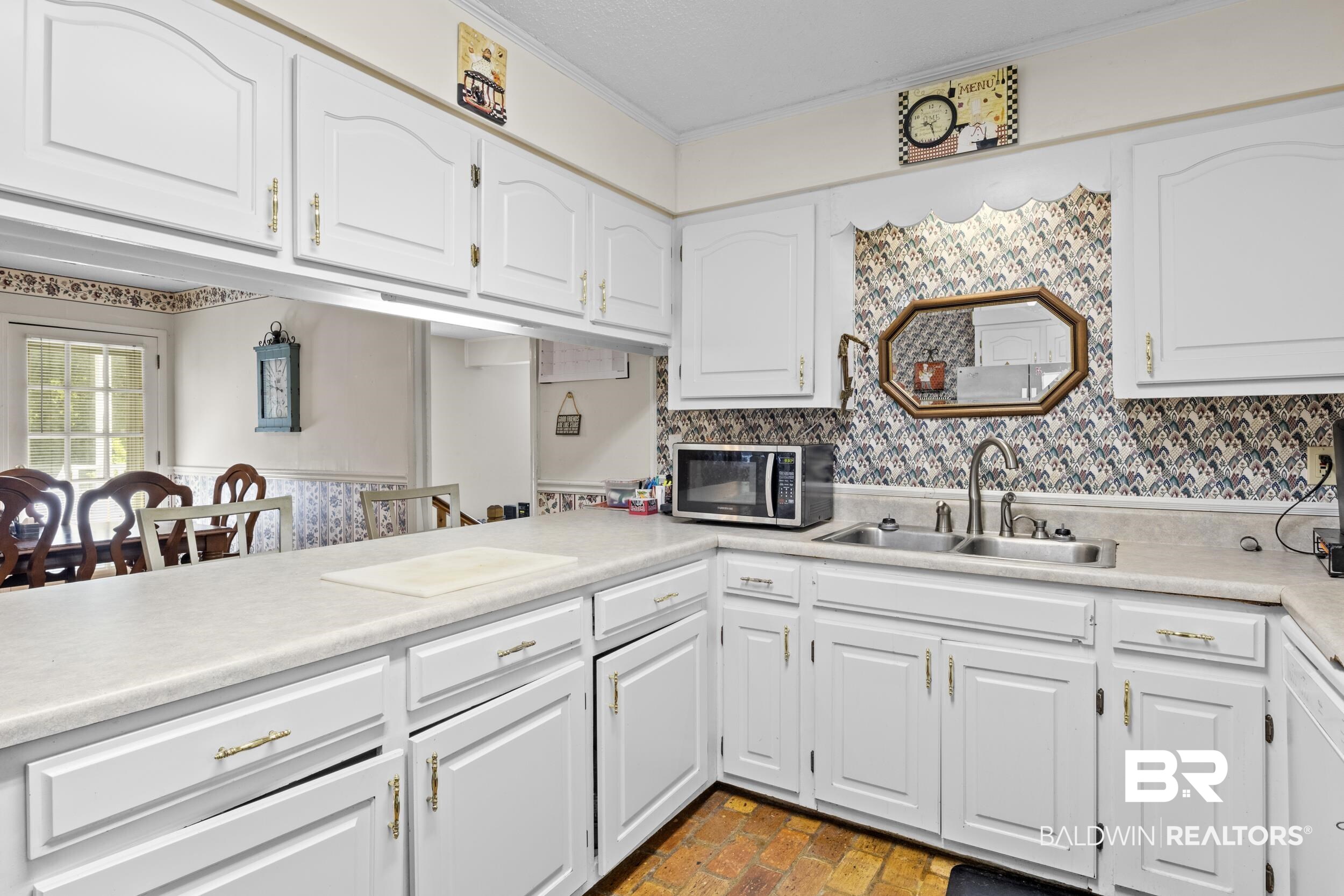 8701 A Rosemary Road Eight Mile, AL 36613 - Photo 9 of 27 Kitchen featuring tasteful backsplash, sink, crown molding, and white cabinetry