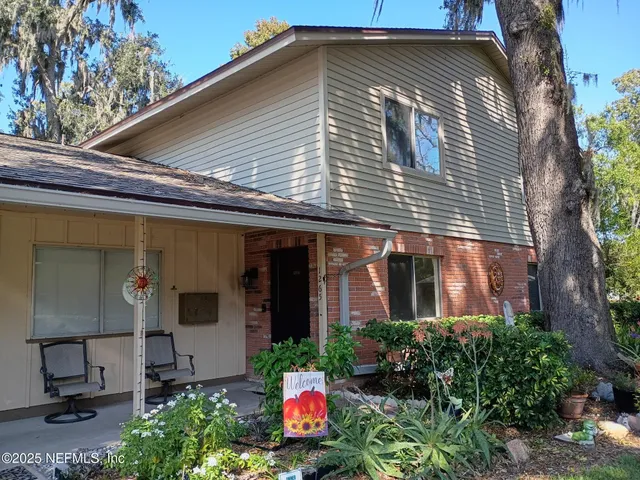 a front view of a house with an outdoor seating