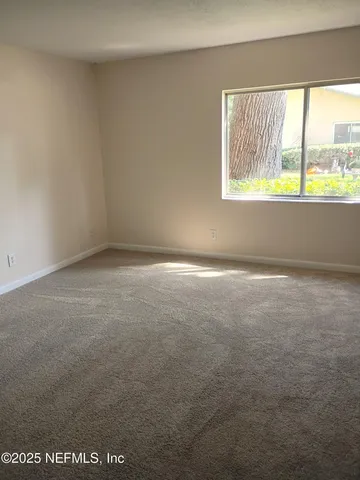 a view of an empty room with a window