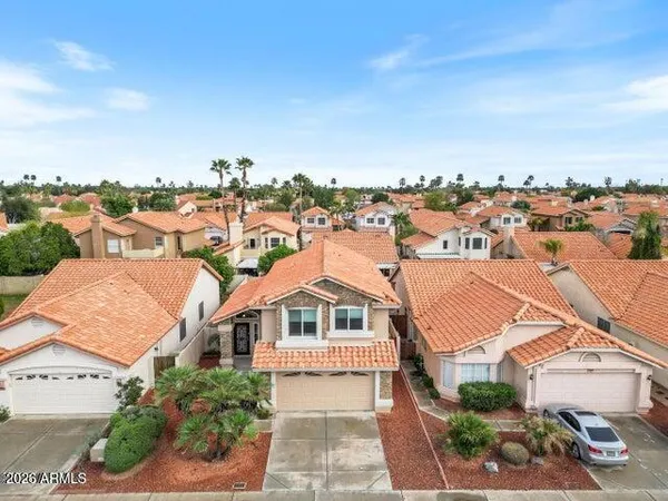 an aerial view of a house with a yard