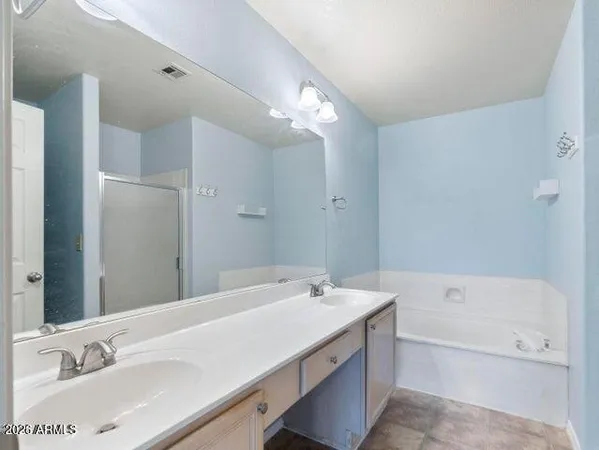 a bathroom with a tub sink double and mirror