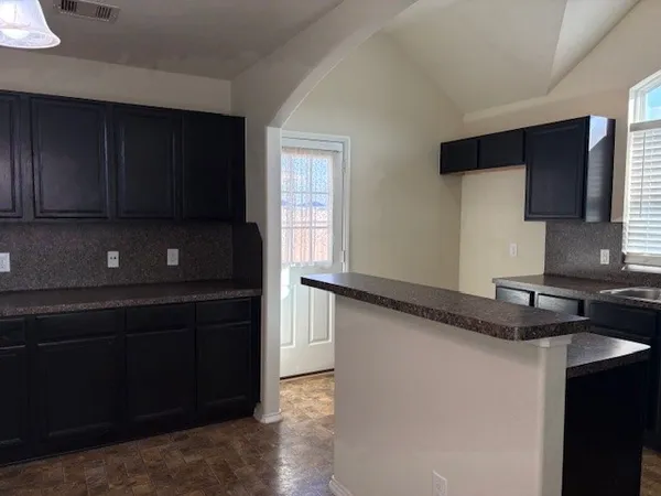 a kitchen with stainless steel appliances granite countertop a stove and a microwave