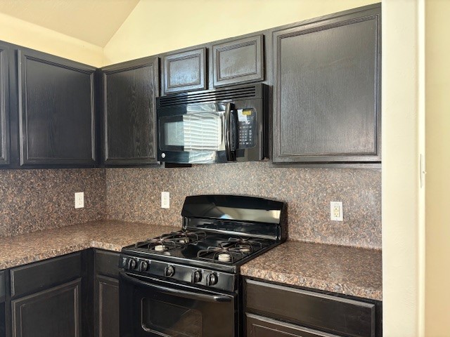 2819 Back Bay Brook Trail Houston, TX 77045 - Photo 16 of 16 a kitchen with stainless steel appliances granite countertop a stove and a microwave