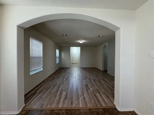 a view of hallway with wooden floor