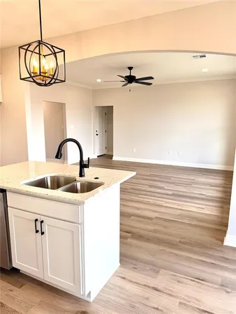 a view of a room with a sink and chandelier
