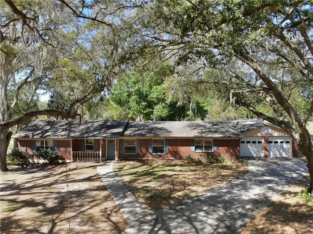 9420 McIntosh Road Dover, FL 33527 - Photo 1 of 1 a view of a big yard with plants and large trees