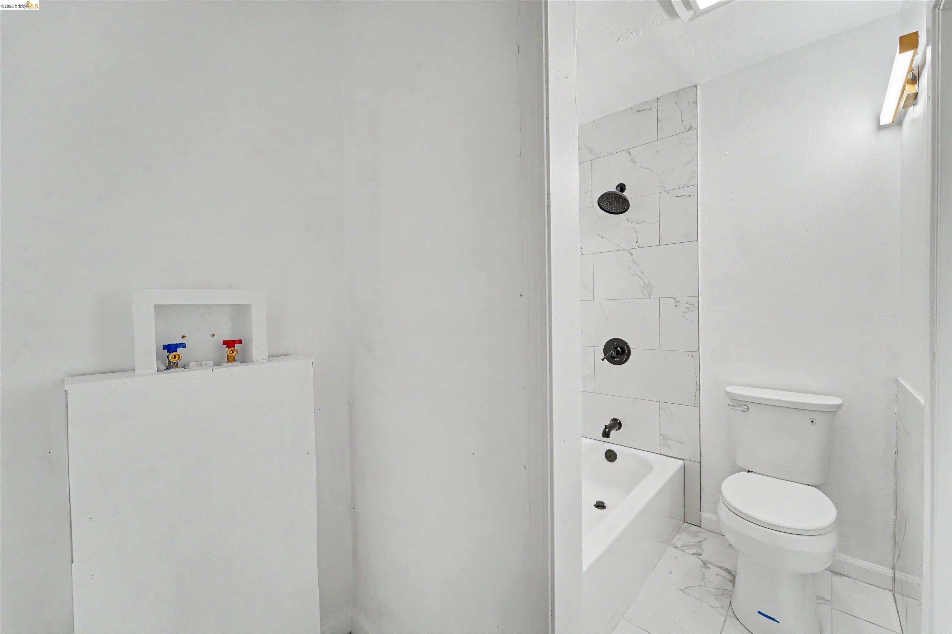 4186 San Pablo Dam Road, Unit A El Sobrante, CA 94803 - Photo 28 of 34 Bathroom featuring a white bathtub with a tile surround, a white toilet, and tile flooring