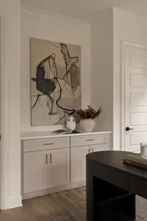 a kitchen with stainless steel appliances a dining table chairs and wooden floor