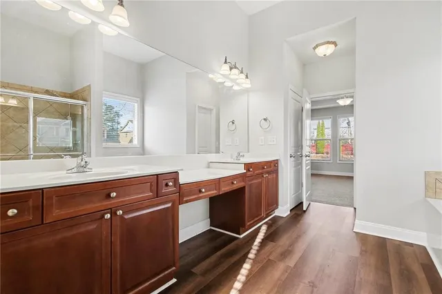 a large bathroom with double vanity sinks a vanity a lamp and a mirror