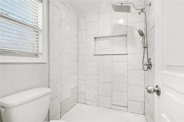 a bathroom with a toilet and shower