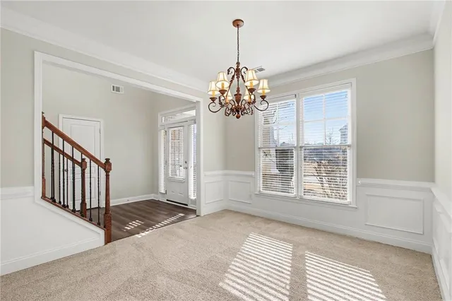a view of a room with wooden floor and windows