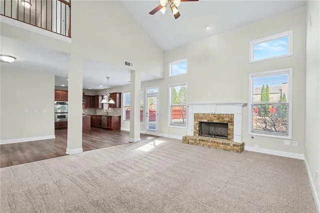 a view of a livingroom with a fireplace cabinet and windows