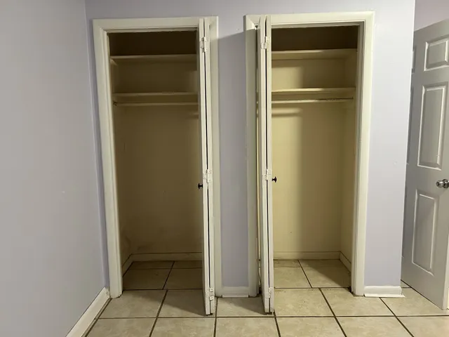 a view of kitchen with walk in closet and empty room