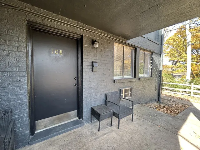a front view of a house with outdoor seating