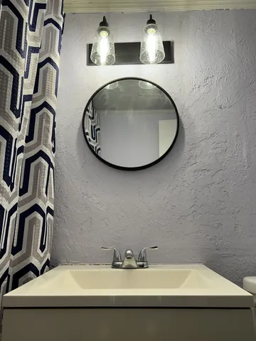 a bathroom with a sink and mirror